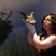Curator of Archaeology Natalie McCaul holding the deer headdress.